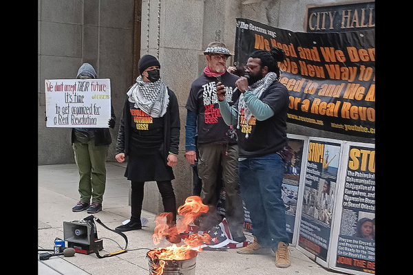 The Revcom Corps for the Emancipation of Humanity in Chicago, including one person who is a Vietnam-era veteran, burned an American flag in front of City Hall, April 1, 2024.