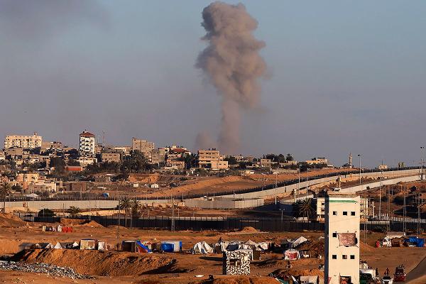 Smoke rises following an Israeli airstrike on buildings near the separating wall between Egypt and Rafah, May 6, 2024.