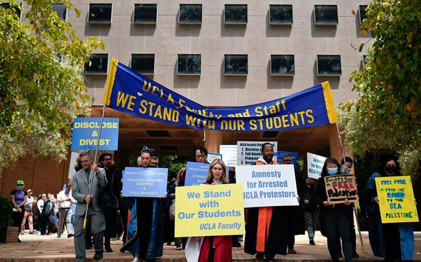 UCLA faculty and staff members march on the school campus in support of students protesting for Palestine, May 9, 2024.