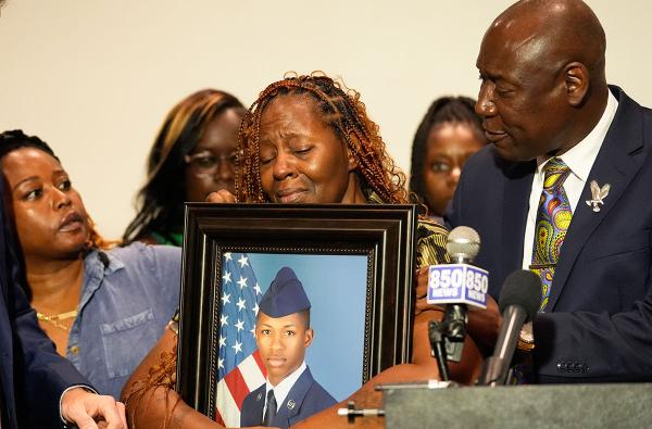 At a press conference, the family supports Chantemekki Fortson with a picture of her son, Roger Fortson, killed at his apartment by Florida cops, May 3, 2024. 