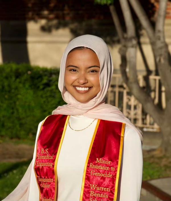 USC 2024 Valedictorian Asna Tabassum in her graduation dress and sash.