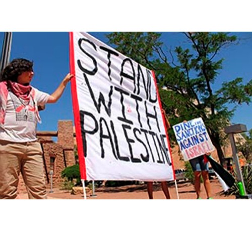 Window Rock, Arizona July 17: Dine (Navajo) activists protest at the Tribal Council against agricultural ties to Israel and to demand a tribal boycott against Israel. Photo: Terry Bowman