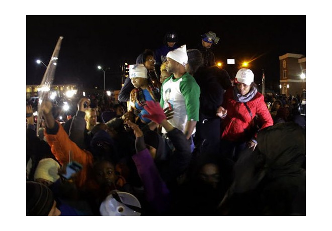 Immediately after the announcement on Monday, November 24, that the grand jury had not indicted the cop who killed Michael Brown, hundreds took to the streets in Ferguson, MO, in outrage—in the face of massive police mobilization, including use of tear gas. Here, Michael Brown's parents and others. Photo: AP