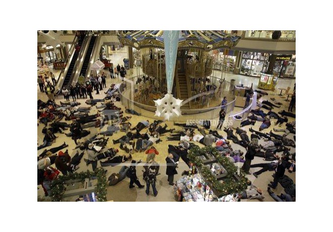 Protesters stage a die in inside Chesterfield Mall, Friday, Nov. 28, 2014, in Chesterfield, MO. photo: AP