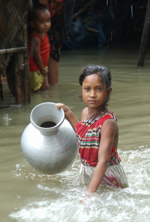 Wading through stagnant rainwater in search of drinking water after a week of deadly storms in the Bay of Bengal