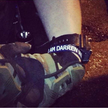 One of the many Ferguson police wearing “I Am Darren Wilson” bracelets.
