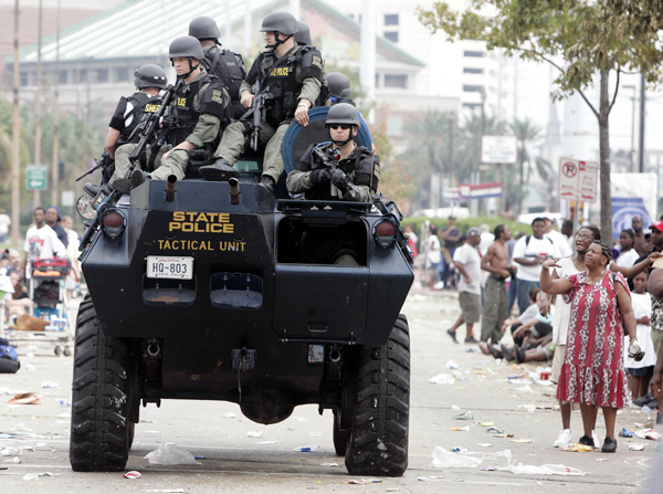 SWAT team drives past flood victims waiting at the Convention Center in New Orleans, Sept. 1, 2005
