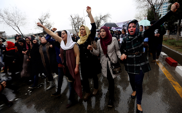 Afghan women protest the death of a woman who was beaten to death by a mob after being falsely accused of burning a Quran.