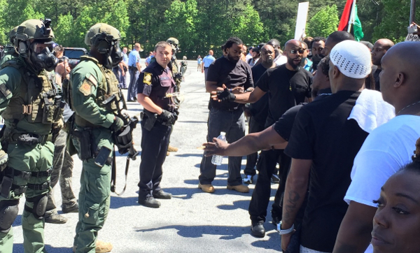 Anti-Klan protesters confront heavily armed law enforcement agents—official enforcers of white supremacy.