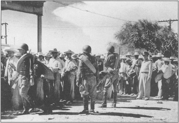 'Operation Wetback' was a U.S. government program of mass deportations of Mexican workers in the early 1950s. Above, Mexican officers guarding deportees awaiting train into Mexico at the Mexican side of the border. 