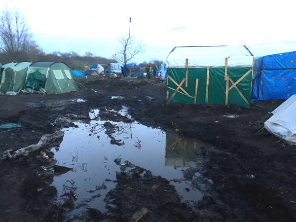 An unauthorized camp for refugees trying to get to Britain has sprung up in Calais, France. It is called the "Jungle" by the authorities, who provide no services and frequently raid the camp and destroy dweillings.