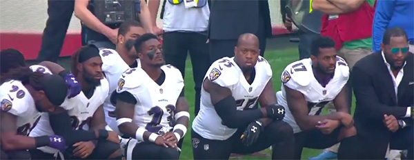 Ravens take a knee during the National Anthem.