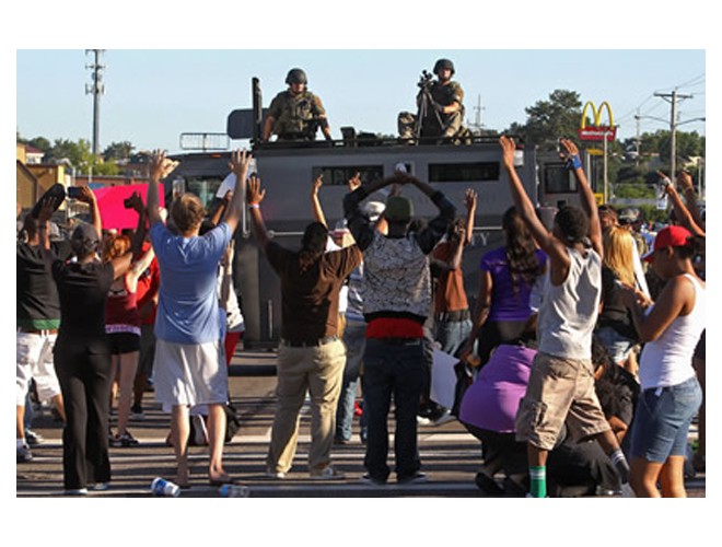 Protesters confront police who are on top their armored vehicle, Ferguson, August 13.  Photo: AP
