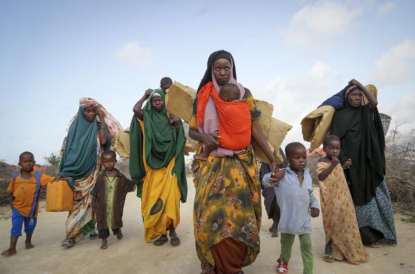 Somali families flee drought stricken area, June 2022.  Tens of millions of people are being uprooted by natural disasters due to the impact of climate change.