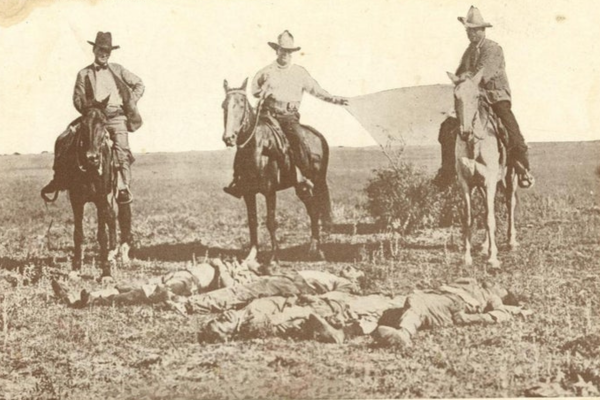 The bodies of three Mexicans who were lynched in Texas being dragged to town by three Texas rangers, 1915.