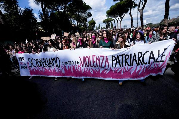 IWD Italy: women march with a banner against patriarchal violence