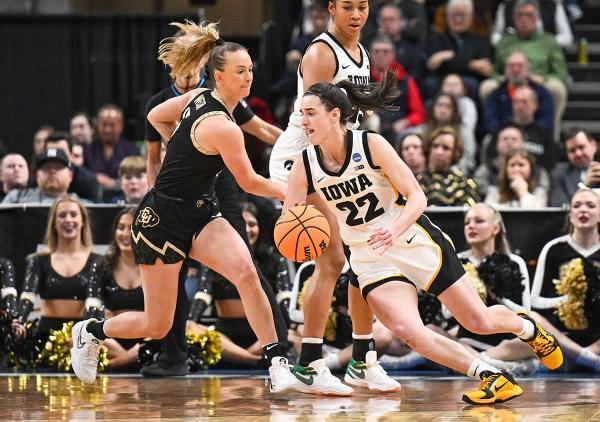 Caitlin Clark (22) dribbles the ball for Iowa in a college basketball game against Colorado in the NCAA Tournament in Albany, N.Y., March 30, 2024.