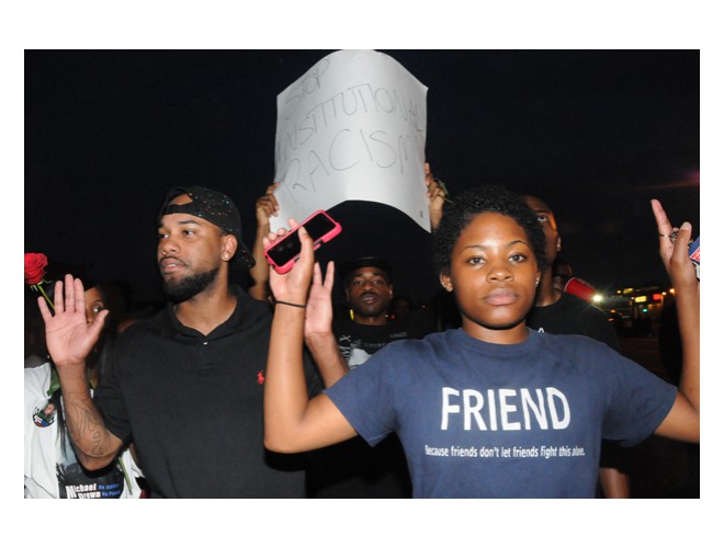 Monday night, August 18, on the ground in Ferguson.  T-shirt reads: 'Friend: Because friends don't let friends fight this alone.' Photo: Li Onesto/revcom.us