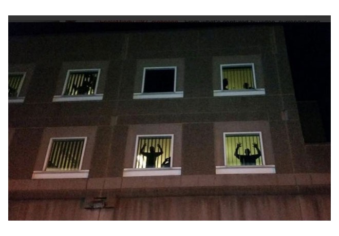 Inmates at Southbay Prison, Boston, banged on windows, flipped lights on an off, and held their hands up in the windows in protest of  the grand jury decision. Nov 25, 2014. Photo: Twitter.