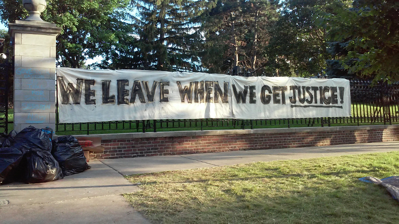 “WE LEAVE WHEN WE GET JUSTICE!”—hung near entrance of the governor’s mansion. 