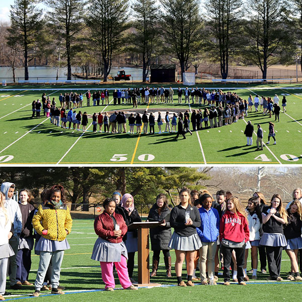 Students at John Carroll High School walk out and form a circle on the football field.