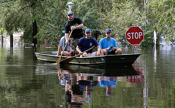 Residents of Lumberton navigate flooded streets in search of people who need help.