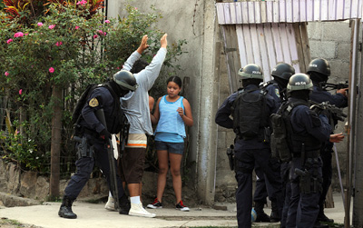 Honduran police break into house and frisk man