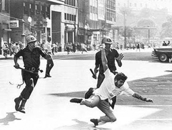 A protestor against the 1964 coup in Brazil is pursued by police.