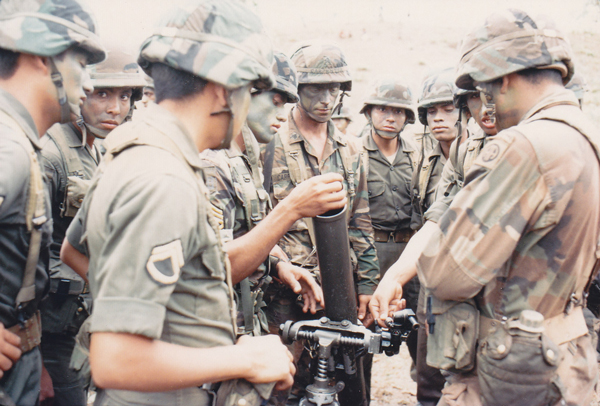 Honduran soldiers operate a mortar for members of the U.S. Army 82nd Airborne Division during a joint exercise, March 1988. 