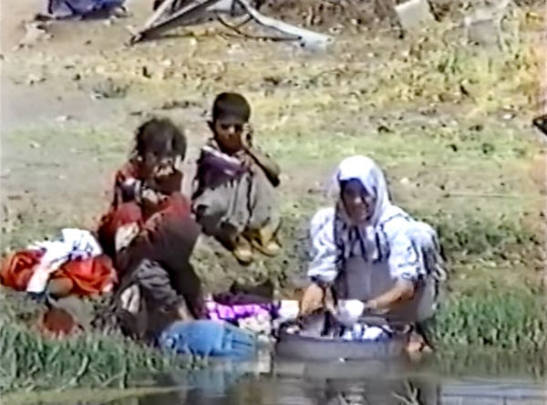 A family in Iraqi Kurdistan washing clothes in polluted water, 1991. 