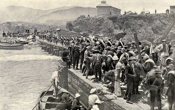 A U.S. invasion force commanded by Teddy Roosevelt lands at Santiago de Cuba.