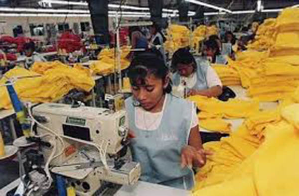 Women work in a crowded maquiladora.