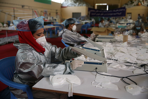 Afghan workers make PPE