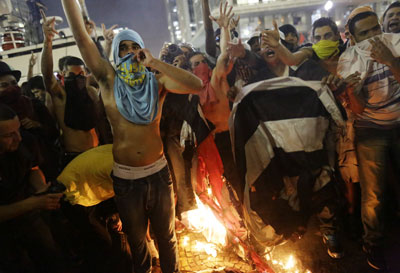 Protestors burn a Sao Paulo state flag in front of City Hall, in Sao Paulo, June 18, 2013.