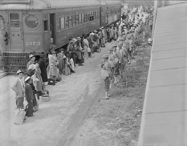 People of Japnese descent lined up at a train that will take them to the concentration camp at Gila River, Ariz., 1942.