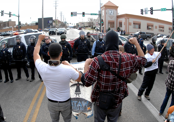 Dakota Pipeline protesters and cops face off during march from state Capitol to the Federal Building, November 14, Bismarck, ND.