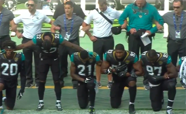 Jaguars take a knee during the National Anthem.