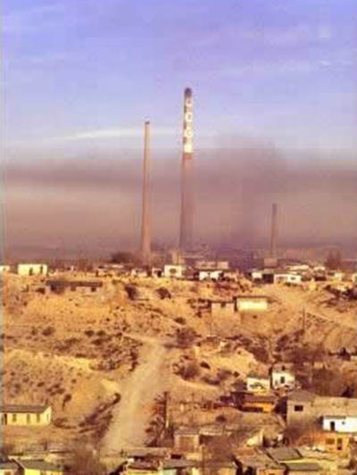 Smokestacks in the midst of Ciudad Juarez's brown smog skyline.