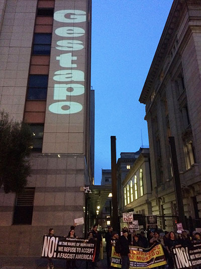 RefuseFascism activists block ICE HQ in San Francisco, while Gestapo prjected onto the  building