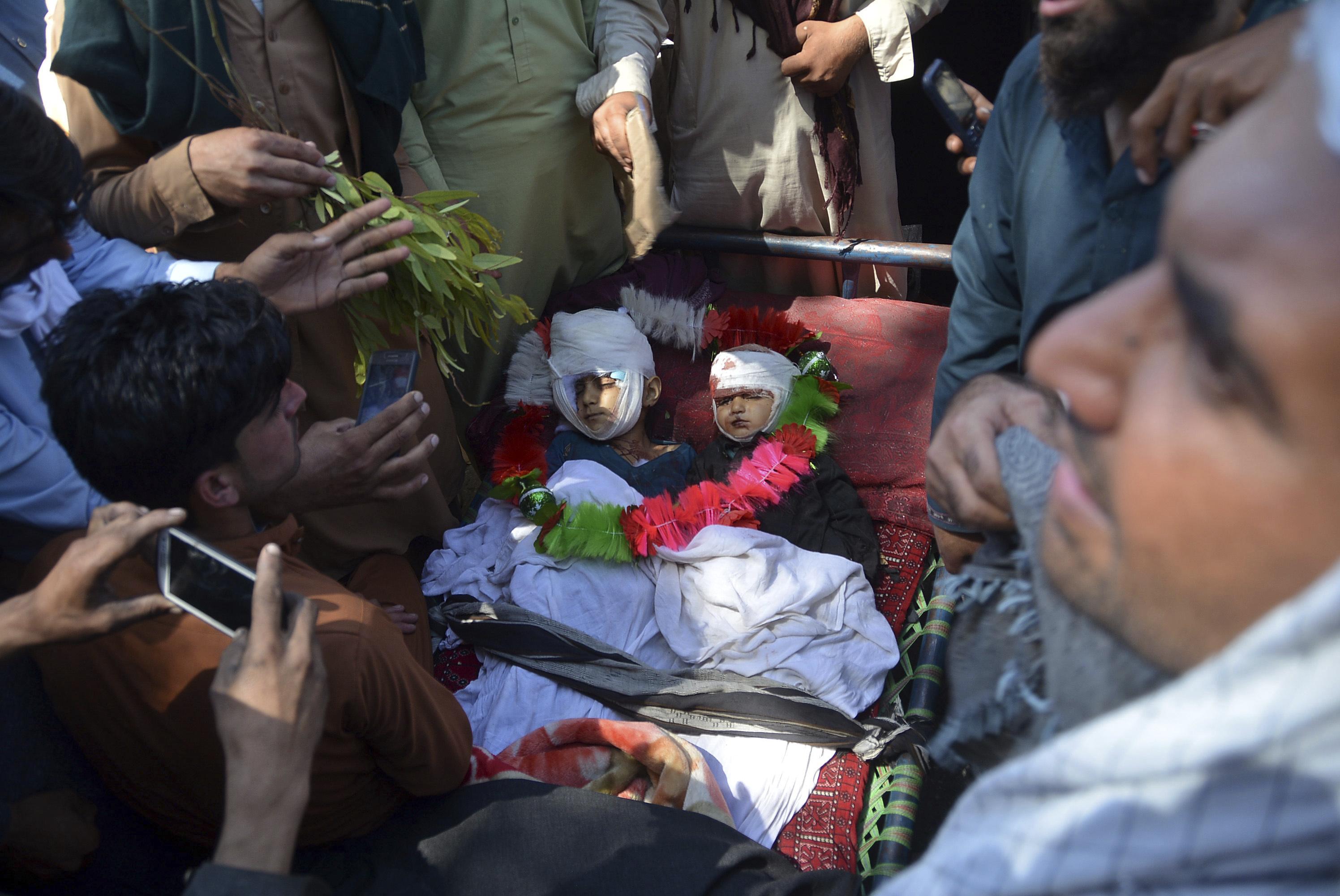 People in Afghanistan mourn civilians killed by U.S. airstrikes.