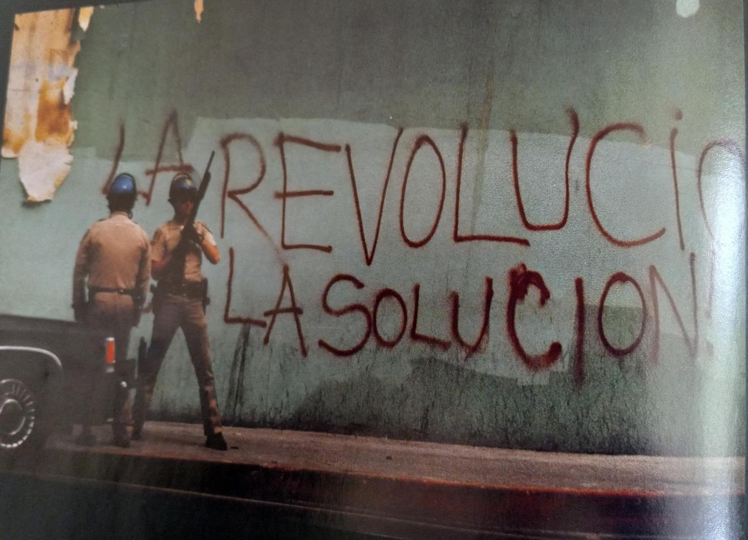 After beating of Rodney King, graffiti on wall in LA: Revolución La Solución.