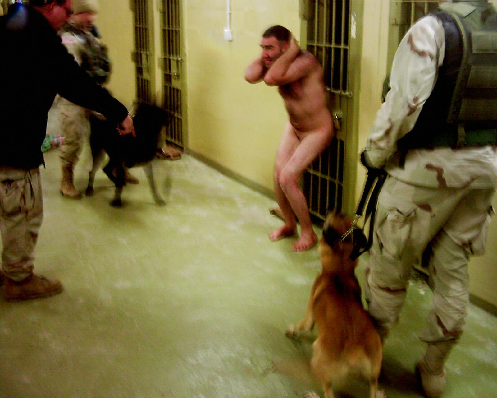 Torturing a naked prisoner with a dog at Abu Ghraib 2003.