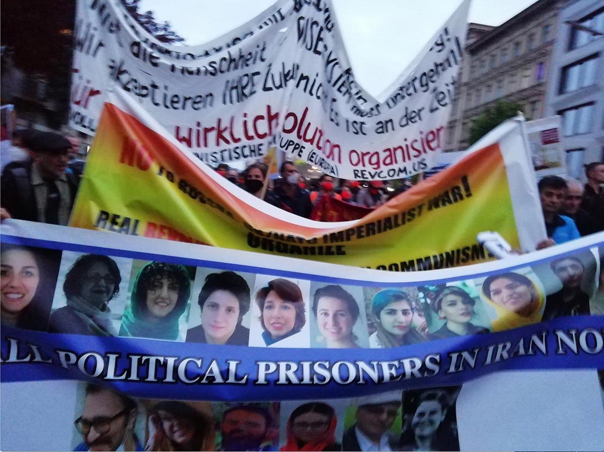 May Day march in Berlin, Germany with banners supporting Iranian political prisoners.