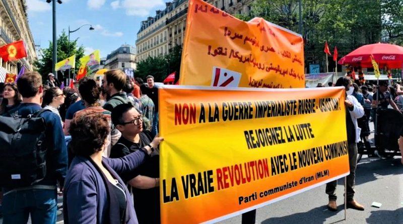 People carry Banner from the CPI-MLM at a May 1 demonstration in Paris