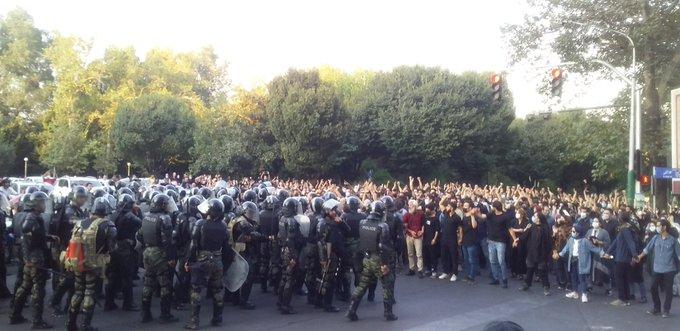 Protesters block police in central Tehran September 19, 2022.