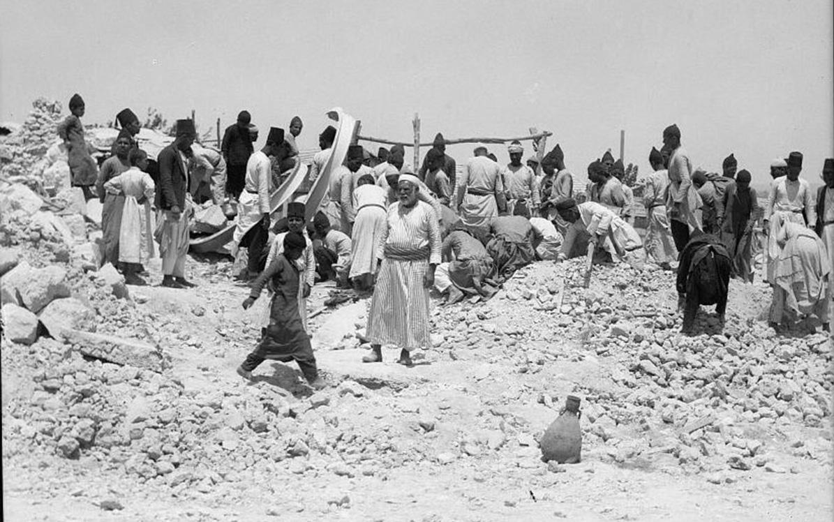 1936, Palestinians search through rubble left from British dynamiting their homes in Lydda.