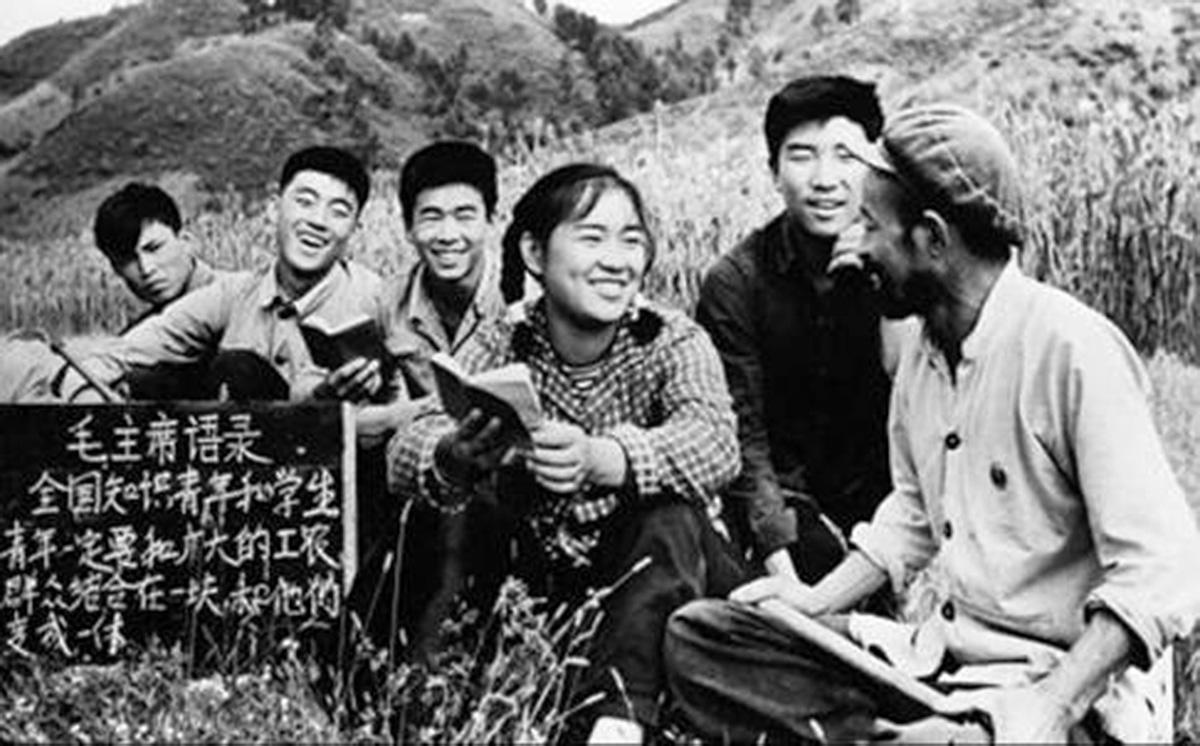 Peasants in the countryside study Mao Red Book, during revolutionary China.