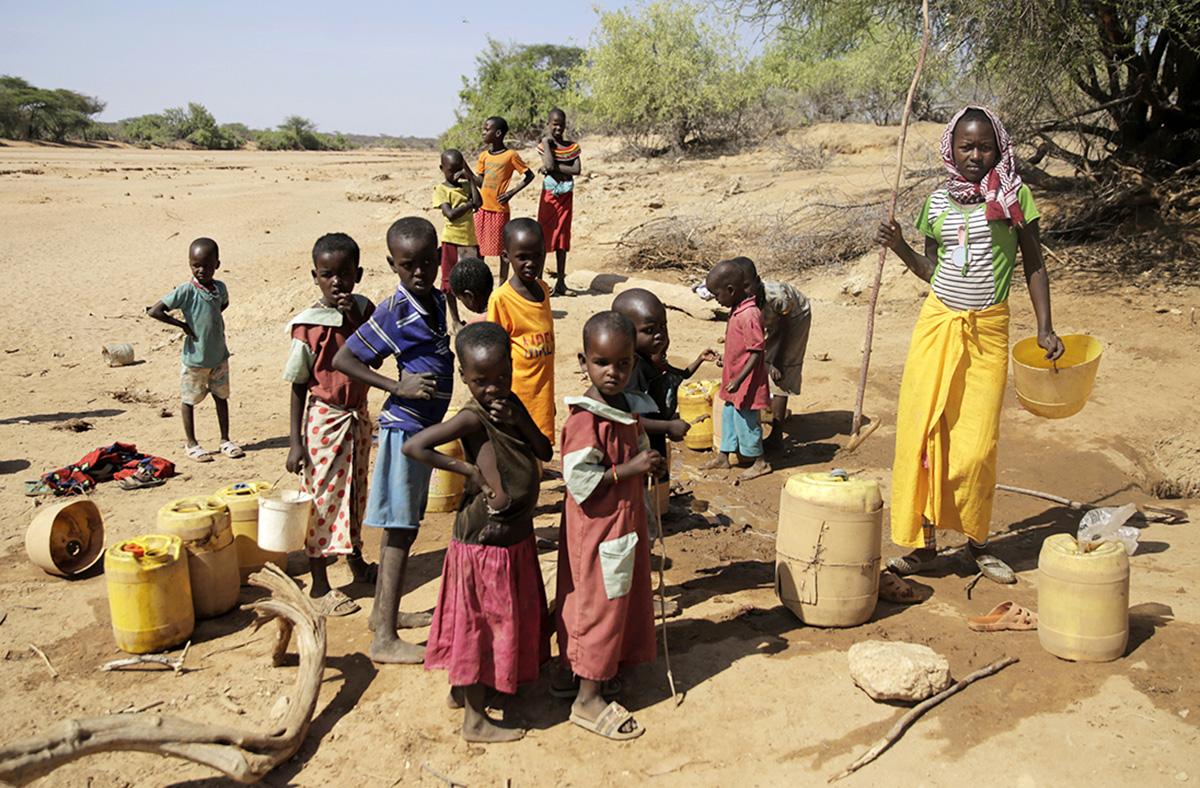 In drought-striken Kenya, children fetch water from ground water well.