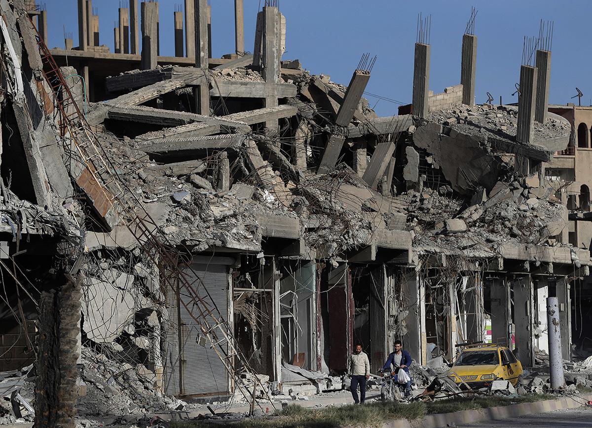 Syria, buildings on street in Raqqa destroyed by bombing by U.S.-led coalition.