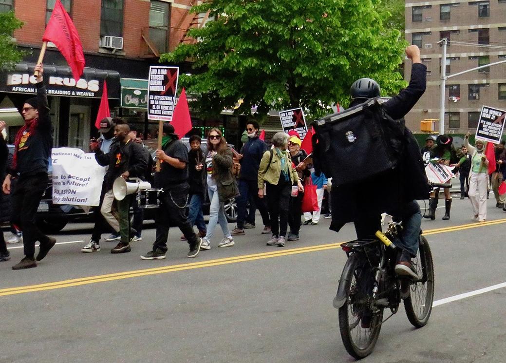 New York City, May First, biker salutes the march